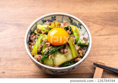 Stir-fried rice bowl with oyster sauce, Chinese bok choy and minced pork (topped with egg yolk) 126784594