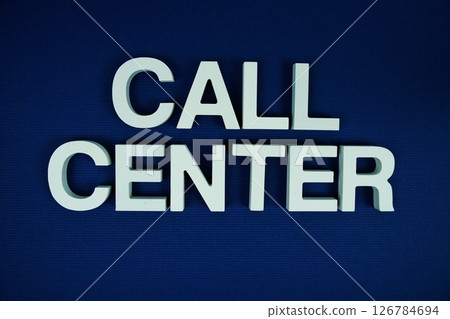 Call Center alphabet letters top view on navy blue background Call Center alphabet letters top view on navy blue background 126784694
