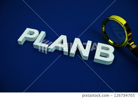 Plan B alphabet letters with magnifying glass top view Plan B alphabet letters with magnifying glass top view 126784703