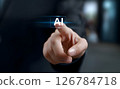 Finger pressing AI button on virtual interface. Touchscreen technology concept with AI sign. Businessman activating artificial intelligence on digital screen. 126784718