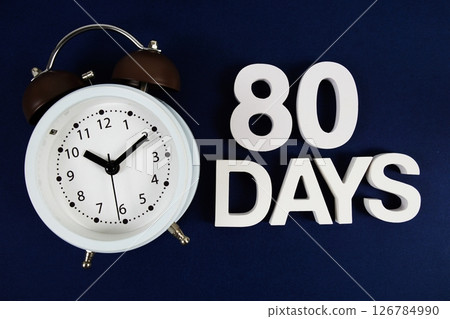 80 Days alphabet letters with alarm clock on navy blue background 126784990