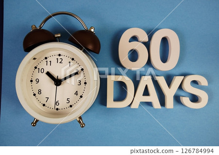 60 Days alphabet letters with alarm clock on blue background 60 Days alphabet letters with alarm clock on blue background 126784994