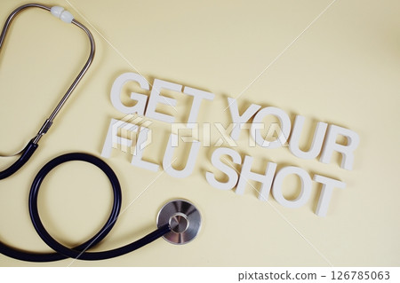 Get Your Flu Shot alphabet letters with stethoscope top view on yellow background Get Your Flu Shot alphabet letters with stethoscope top view on yellow background 126785063