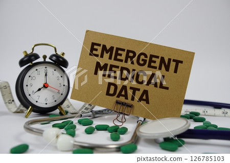 Emergent Medical Data text with alarm clock and Stethoscope on white background Emergent Medical Data text with alarm clock and Stethoscope on white background 126785103