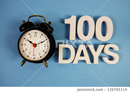 100 Days alphabet letters with alarm clock on blue background 100 Days alphabet letters with alarm clock on blue background 126785114