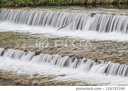 Water flowing vigorously down the weir, Takano River, Kyoto City Water flowing vigorously down the weir, Takano River, Kyoto City 126785390