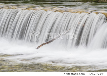 Water flowing vigorously down the weir, Takano River, Kyoto City 126785393