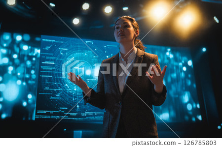 A woman is speaking on stage A woman is speaking on stage 126785803