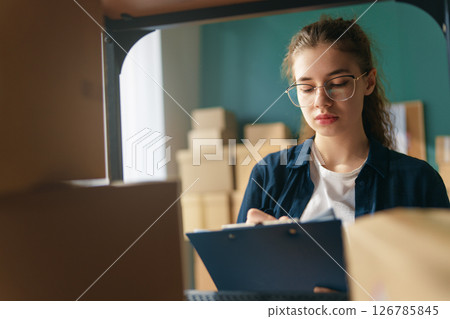 Woman working in a warehouse Woman working in a warehouse 126785845