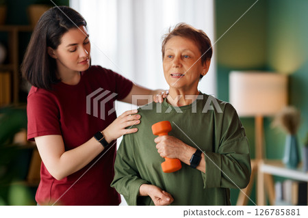 Senior woman doing dumbbell exercise Senior woman doing dumbbell exercise 126785881