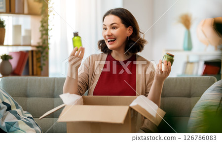 Woman is unpacking cardboard 126786083