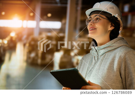 Young woman is working in warehouse 126786089