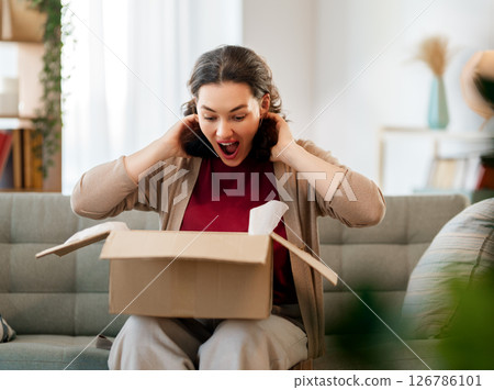 Woman is unpacking cardboard 126786101