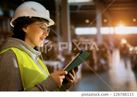 Young woman is working in warehouse Young woman is working in warehouse 126786115