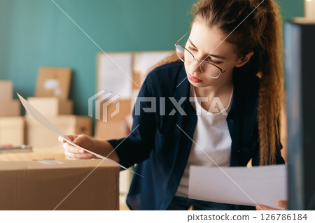 Woman working in a warehouse. 126786184