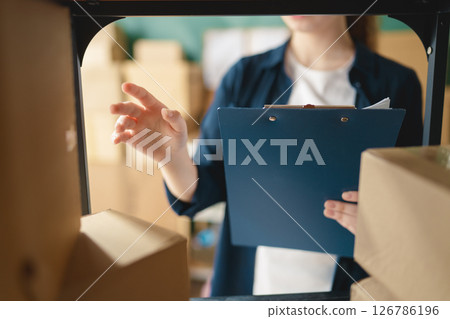 Woman working in a warehouse. Woman working in a warehouse. 126786196