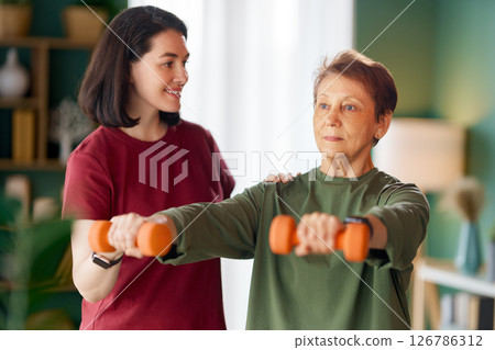 Senior woman doing dumbbell exercise Senior woman doing dumbbell exercise 126786312