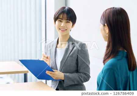 Two businesswomen having a meeting in an office. Photo courtesy of Sky Perfect Tokyo Media Center. Two businesswomen having a meeting in an office. Photo courtesy of Sky Perfect Tokyo Media Center. 126786409