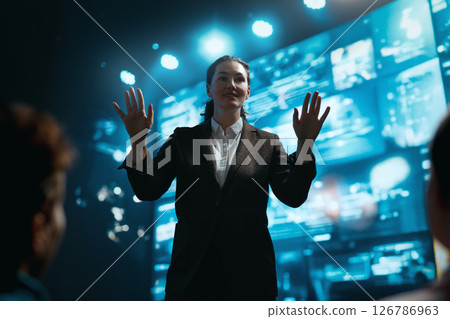 A woman is speaking on stage A woman is speaking on stage 126786963