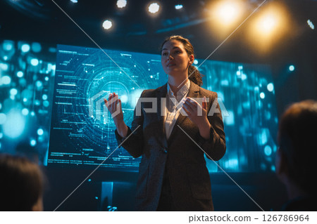A woman is speaking on stage A woman is speaking on stage 126786964