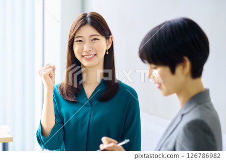 Two businesswomen having a meeting in an office. Photo courtesy of Sky Perfect Tokyo Media Center. Two businesswomen having a meeting in an office. Photo courtesy of Sky Perfect Tokyo Media Center. 126786982