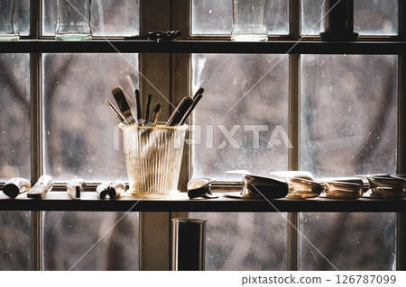 Tools and brushes by the window 126787099