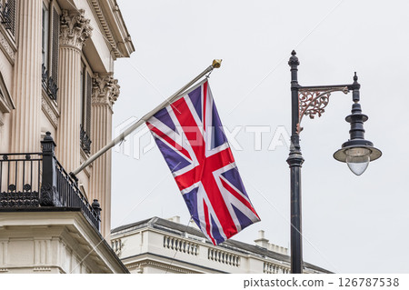 British Union Jack Flag Flying Outside Classical London Building with Street Lantern 126787538