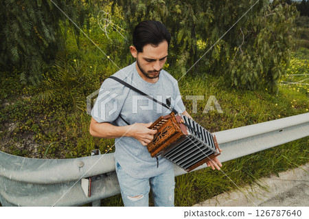 Man Playing Accordion On The Side Of The Road Man Playing Accordion On The Side Of The Road 126787640