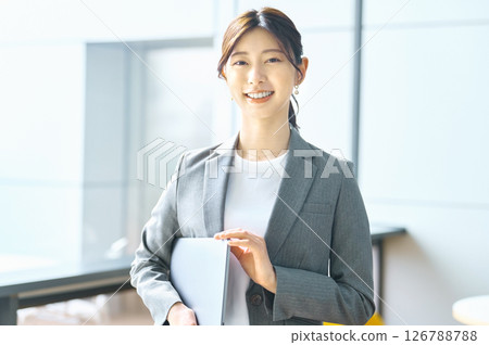 Young businesswoman working in an office. Photo courtesy of Sky Perfect TV Tokyo Media Center. Young businesswoman working in an office. Photo courtesy of Sky Perfect TV Tokyo Media Center. 126788788