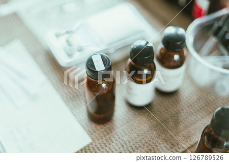 Shot of mature perfumer adding extra essential oil 126789526