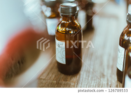 Shot of mature perfumer adding extra essential oil 126789533