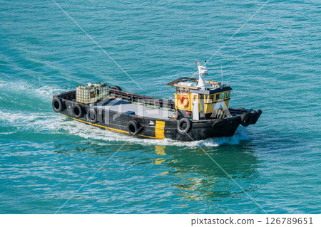 Industrial Tugboat Sailing on Blue Water 126789651