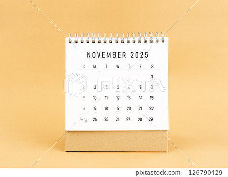 November 2025 desk calendar on yellow background, Front view. November 2025 desk calendar on yellow background, Front view. 126790429