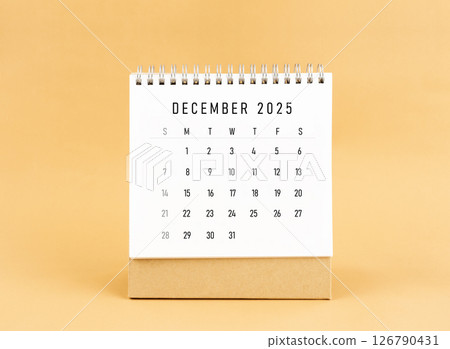 December 2025 desk calendar on yellow background, Front view. December 2025 desk calendar on yellow background, Front view. 126790431