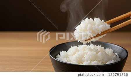 Steam rising from freshly cooked rice 126791716