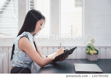 Young asian woman in smart casual wear working in home office. Social distance practice prevent coronavirus COVID-19. 126794380