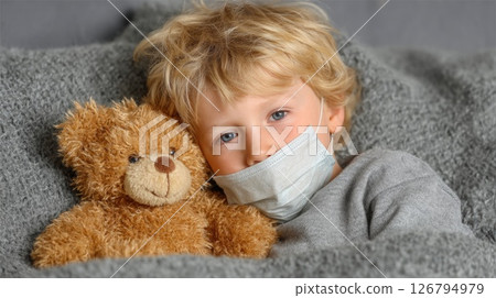 Sick Child Resting with Teddy Bear and Face Mask 126794979