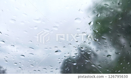 Raindrops and dew on car glass during rain in gray cloudy weather. Condensation on glass, Background. 126795630