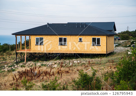 Unfinished house stands on piles in Crimea near Koktebel White Rock 126795943