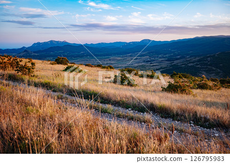 Golden hour illuminating Crimean mountains and valley landscape 126795983
