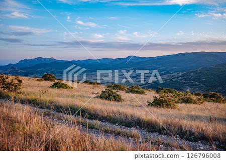 Scenic Crimean Landscape with Rolling Hills and Mountains at Sunset 126796008