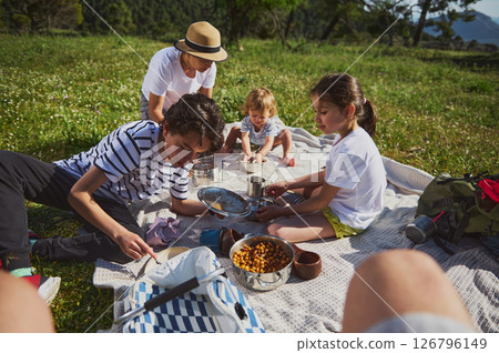Family Enjoying a Picnic in a Natural Mountain Setting 126796149