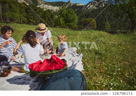 Family Enjoying a Picnic in the Mountains Tasting Tacos Outdoors Family Enjoying a Picnic in the Mountains Tasting Tacos Outdoors 126796151