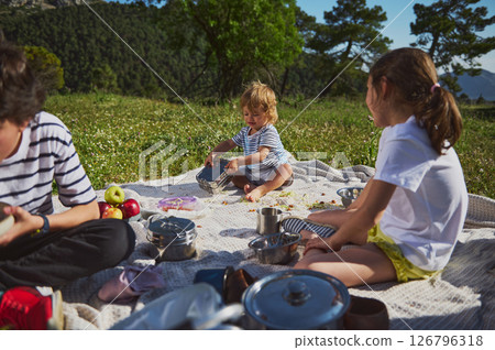 Family Enjoying a Scenic Outdoor Picnic in Springtime 126796318