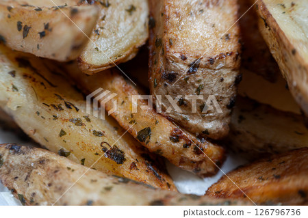 Crispy-on-the-Outside, Tender Potato Wedges Seasoned with Savory Herbs 126796736
