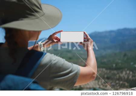 Traveler Taking a Photo of Mountain Scenery With Smartphone 126796918