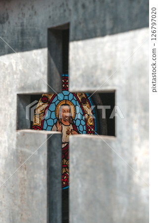 Stained Glass Image of Jesus Seen Through a Metal Cross Opening Stained Glass Image of Jesus Seen Through a Metal Cross Opening 126797020