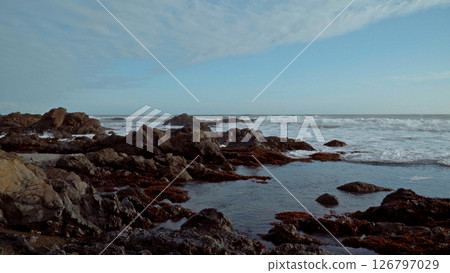 Waves crashing on the rocky California Coast at dusk 126797029