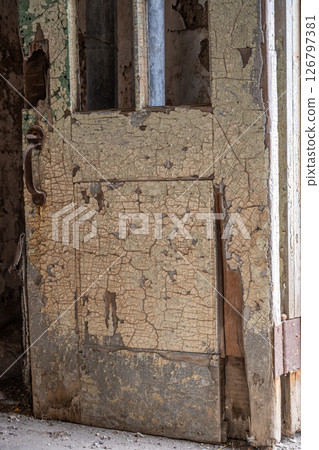 Chipped and peeling lead based paint on an old wall. 126797381