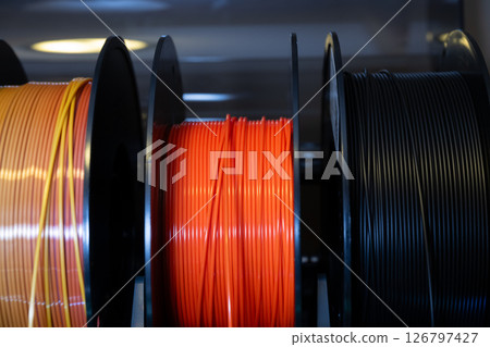 Selective focus on different colored spools of 3d printer filament  126797427